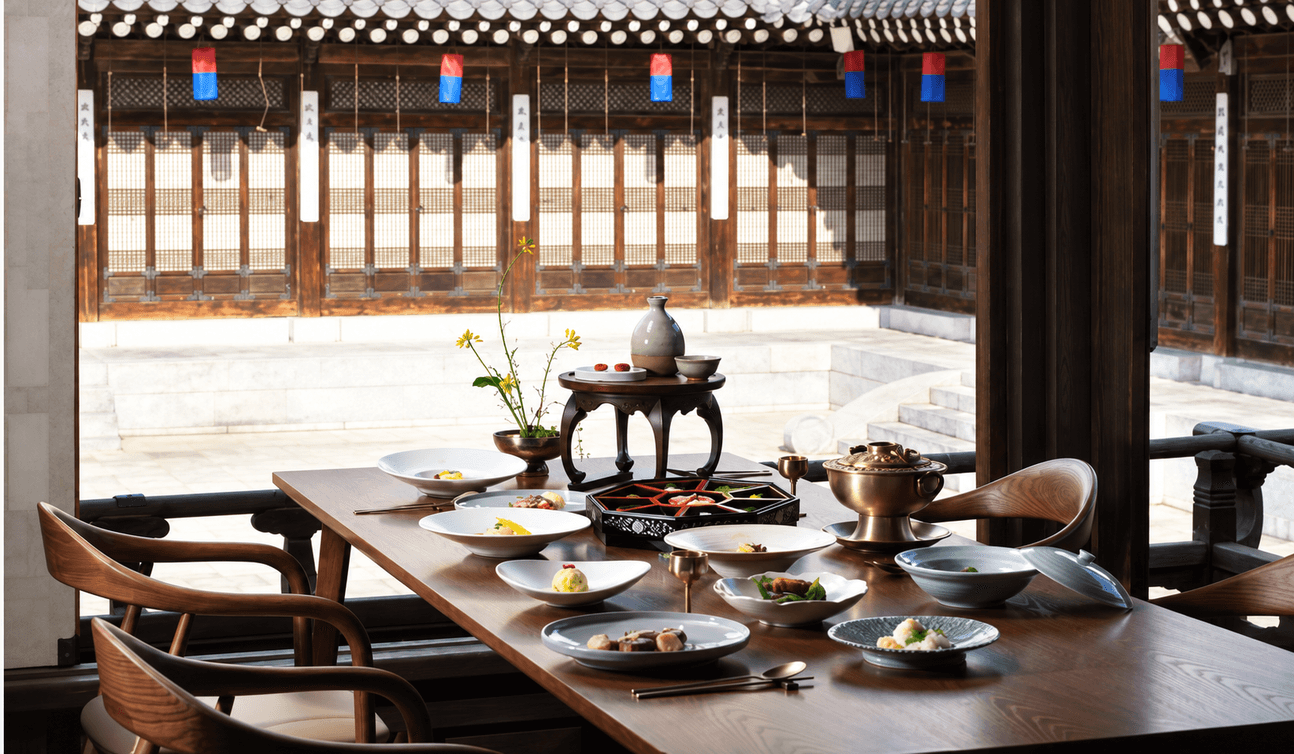 A hanjeongsik table set inside a hanok, looking out onto the courtyard.
