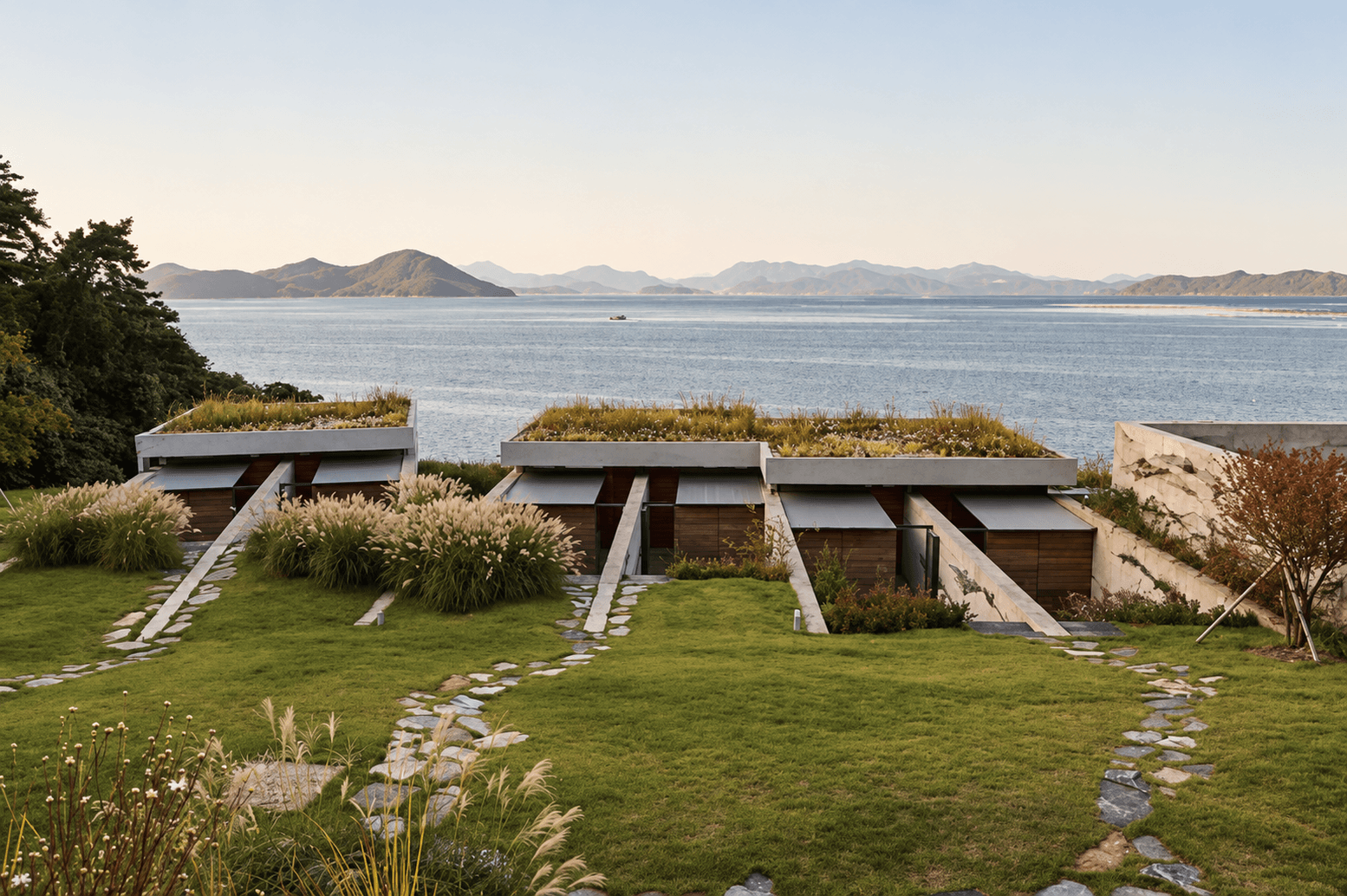 Low buildings with grass roofs on a lawn above the sea at the southern tip of the peninsula.